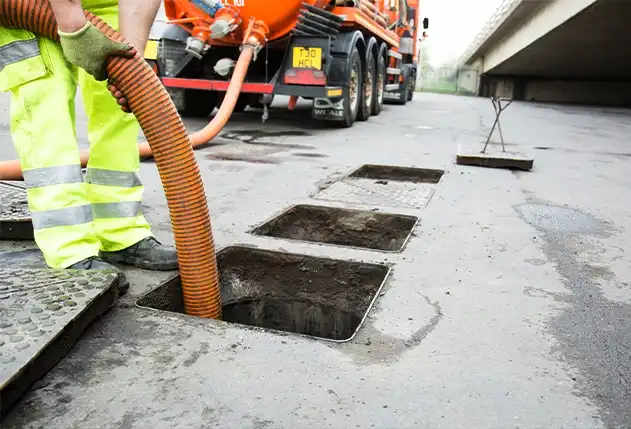 Engineers inspecting sewer system with CCTV crawler